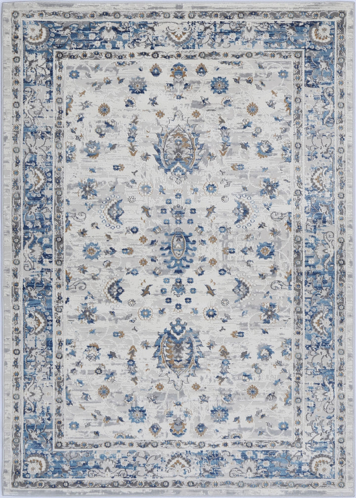 Traditional area rug with intricate blue, ivory, and beige floral patterns and ornate border
