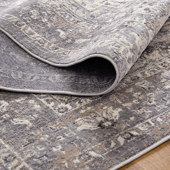 Close-up of a grey and beige patterned area rug with a soft textured surface