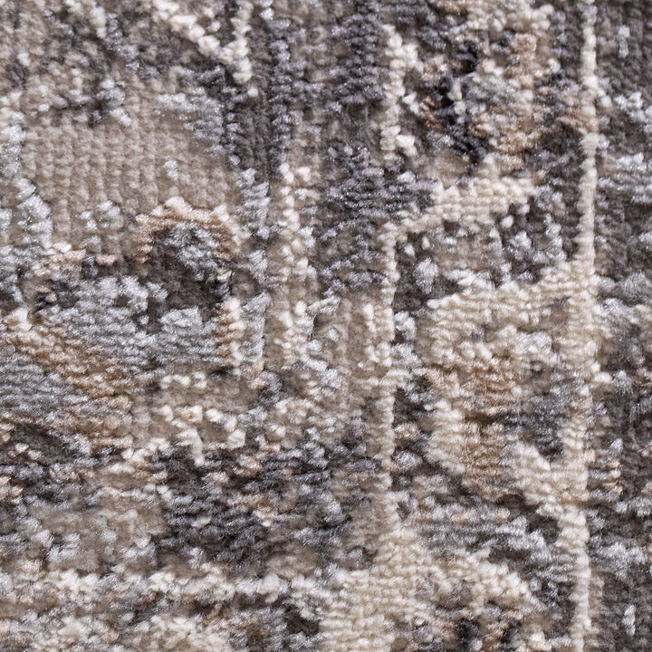 Close-up of textured grey and beige patterned carpet fabric