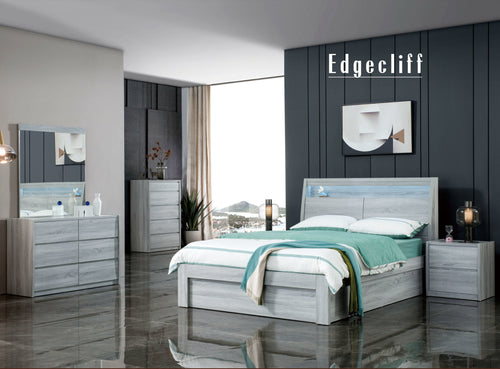 Modern gray bedroom set with bed, dresser, mirror, nightstands, and chest in stylish room