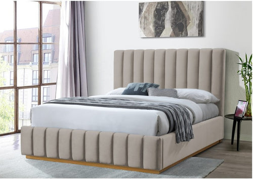 Modern platinum upholstered bed with tall vertical panel headboard in a bright bedroom
