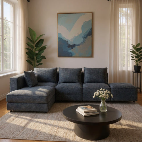 Modern grey sectional sofa with chaise, styled in bright living room with coffee table and abstract art