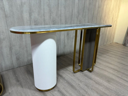 Modern console table with marble top, gold trim, and white ribbed base, ideal for entryway or hallway decor