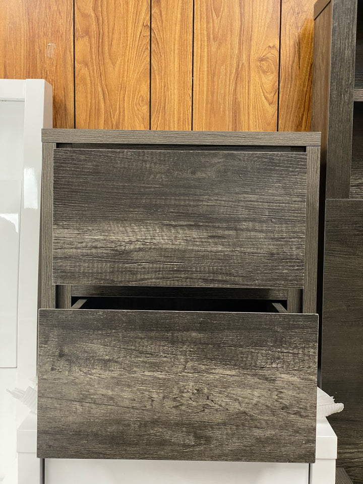 Modern dark wood nightstand with two drawers in front of wood panel wall