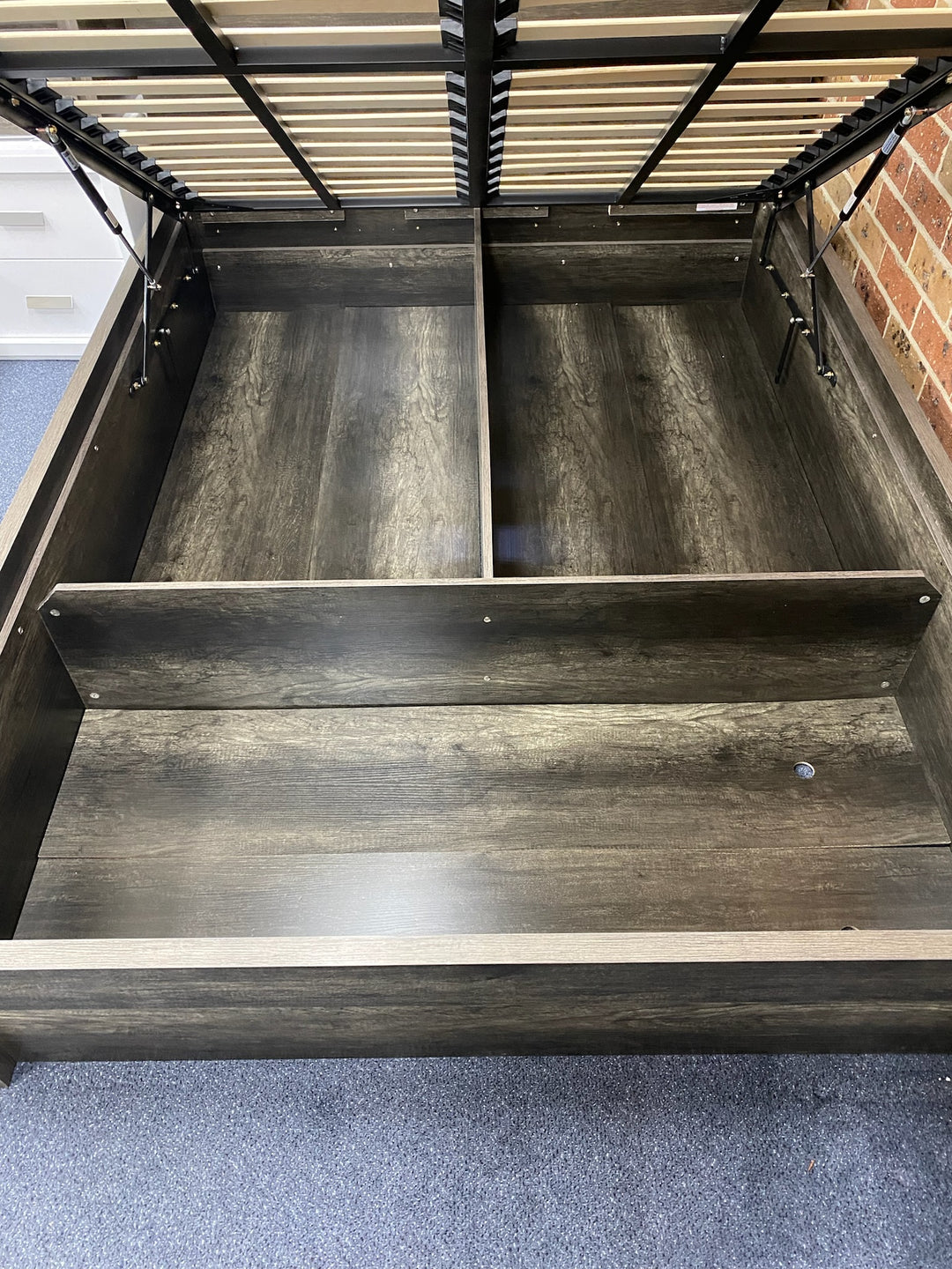 Lift-up storage bed frame with divided wooden compartments and metal slat support