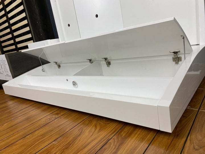 Modern white lift-up storage drawer unit on wooden floor, ideal for home furniture organization.