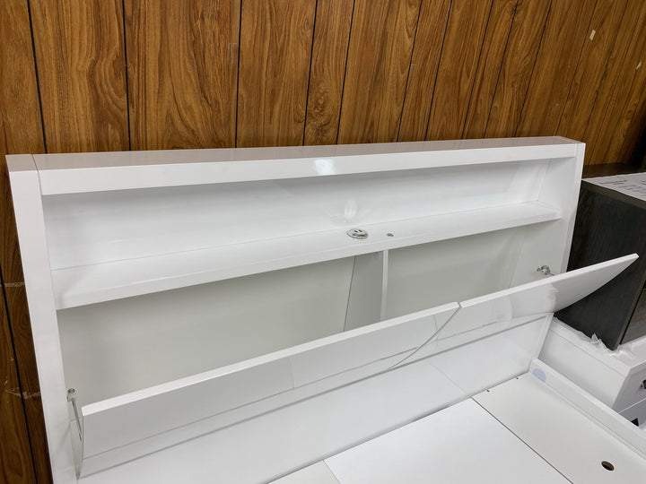 Modern white storage headboard with open compartments against wood panel wall