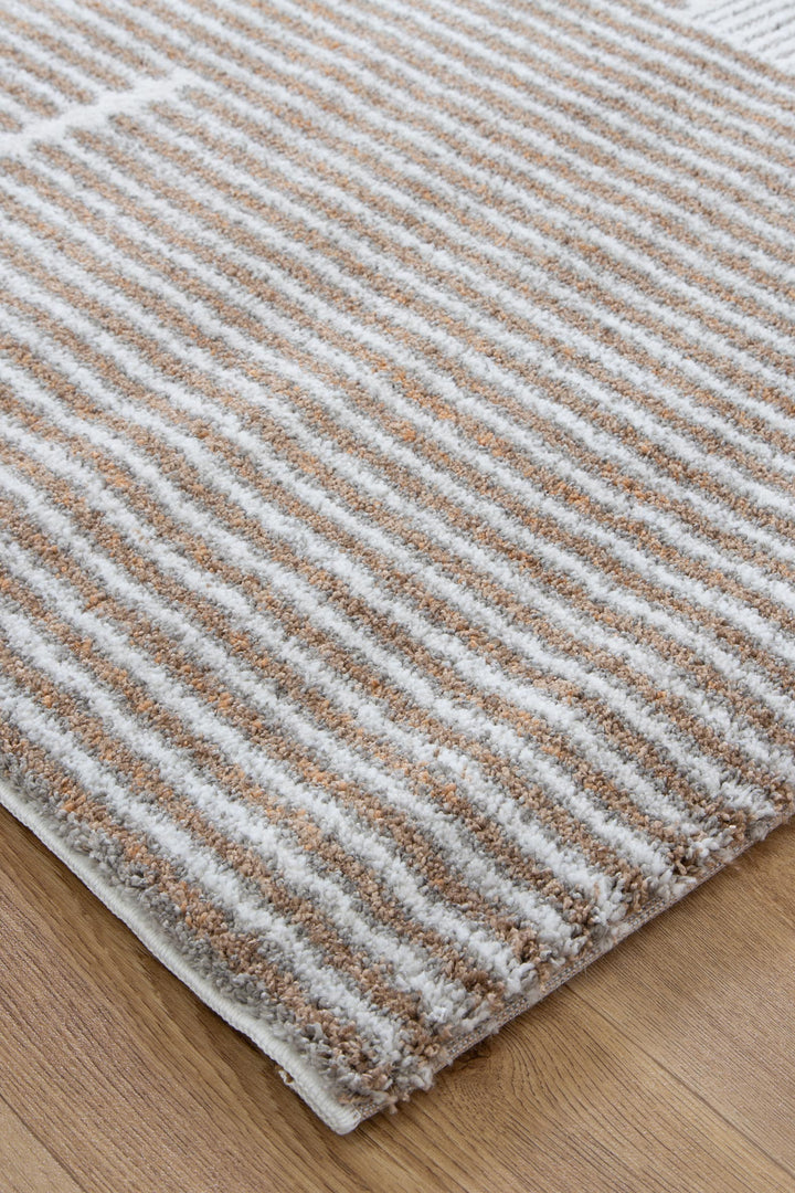 Beige and white striped textured area rug on wooden floor