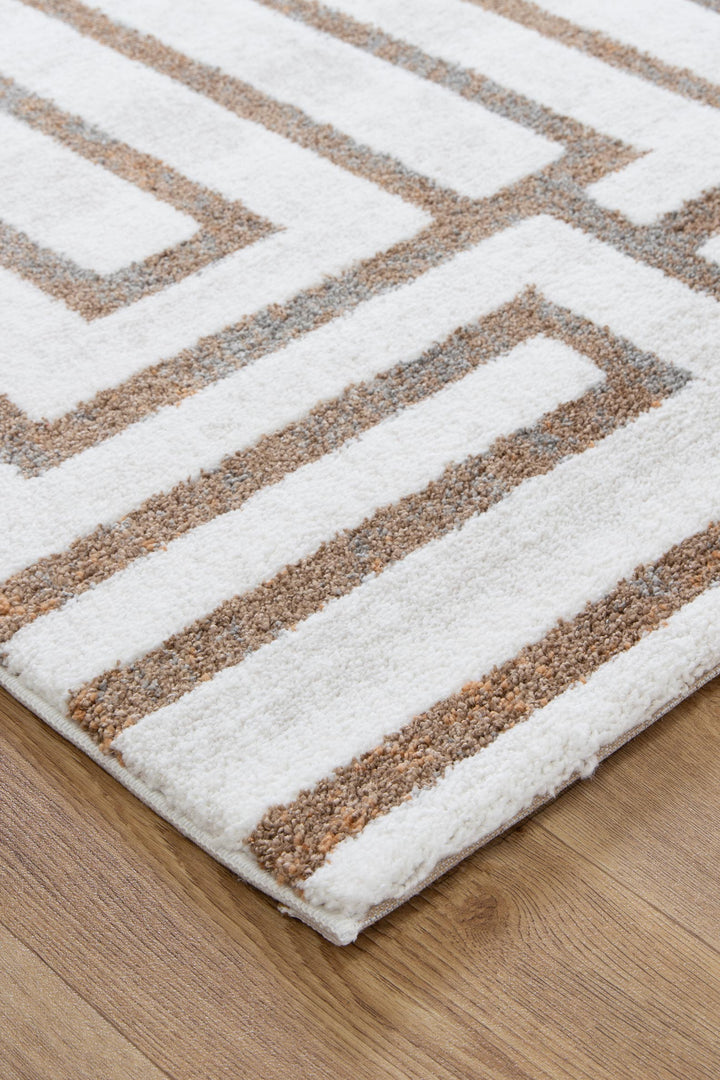 Modern area rug with white base and geometric beige patterns on wood floor