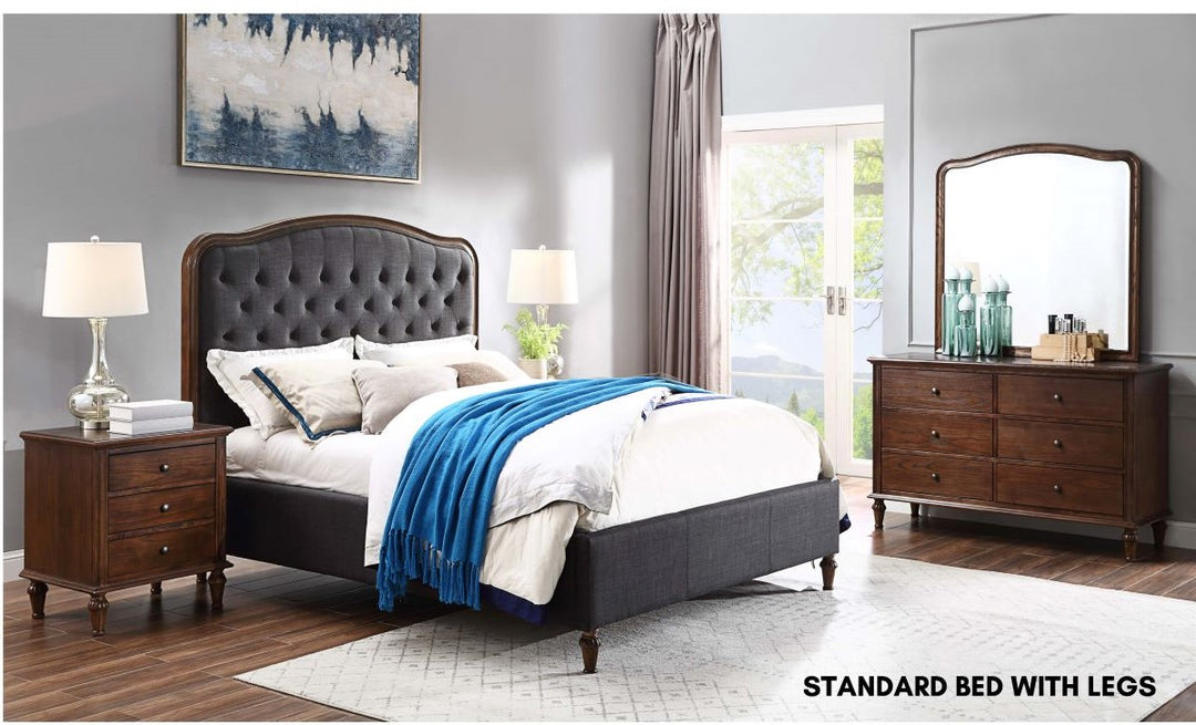 Tufted upholstered bed with legs, wood nightstand and dresser in modern bedroom