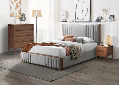 Modern grey upholstered queen bed with wooden frame, matching nightstand and dresser in a stylish bedroom