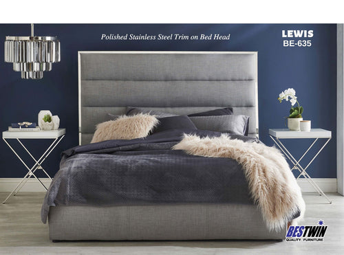 Modern queen bed with grey upholstered headboard, metallic trim, and cozy bedding in stylish bedroom