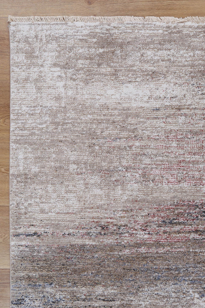 Modern beige area rug with subtle textured pattern on wooden floor