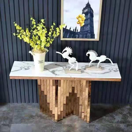 Marble-top console table with geometric wood base, styled with white horse sculptures and greenery for modern entryway decor