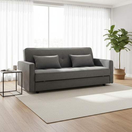 Modern gray sofa bed with cushions in bright living room, ideal for small spaces and guest seating