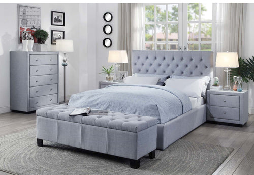 Light grey upholstered bed with tufted headboard in modern bedroom set, matching bench and nightstands