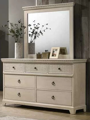 Beige wood dresser with large mirror, six drawers, and decor vases in modern bedroom.