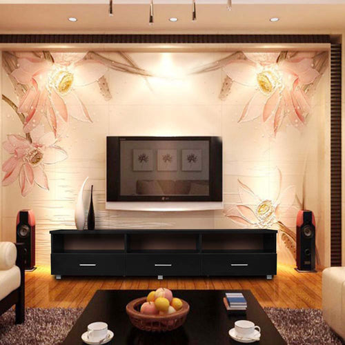 Modern living room with sleek black TV unit, wall-mounted TV, floral accent wall, and cozy decor.
