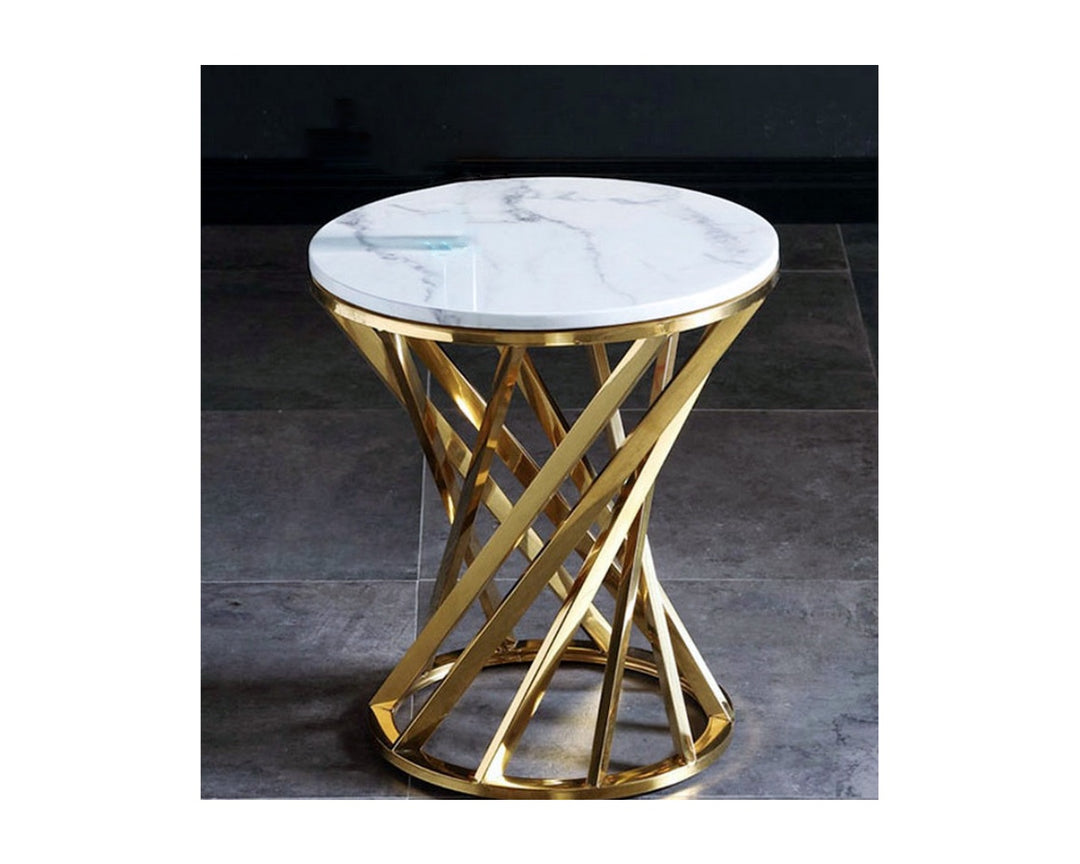 Modern round side table with white marble top and gold metal geometric base on tile floor