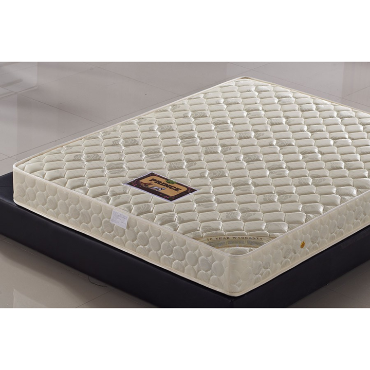 Quilted white mattress with hexagonal pattern on a black bed base in a modern room.
