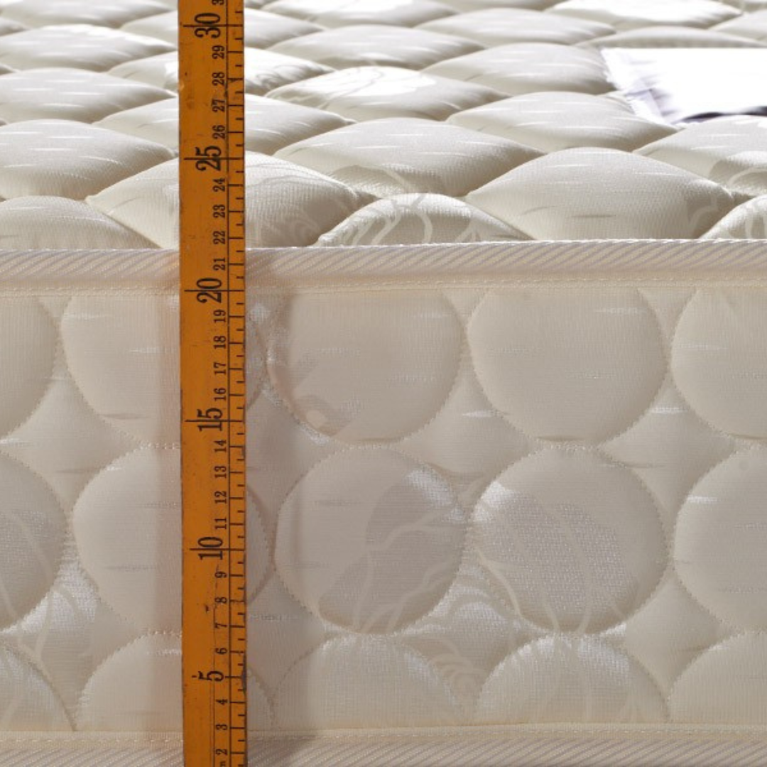 Quilted mattress side with height measured by ruler, quality home bedding detail