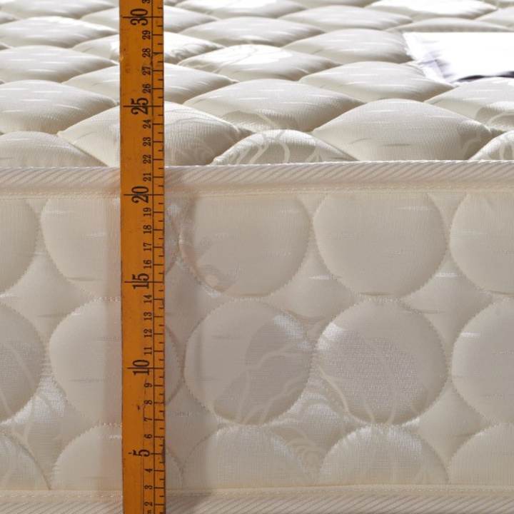 Quilted mattress side with height measured by ruler, quality home bedding detail