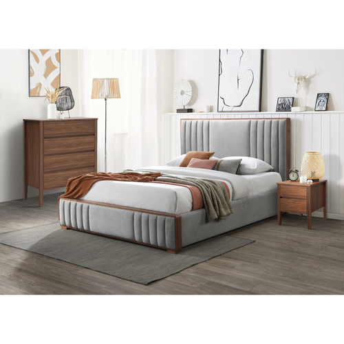 Modern bedroom set with grey upholstered bed, wooden nightstand, and dresser in a bright room