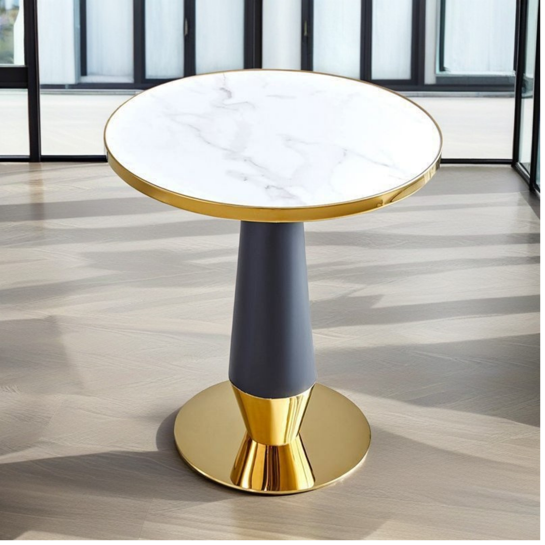 Modern round marble top side table with gold accents in a bright room