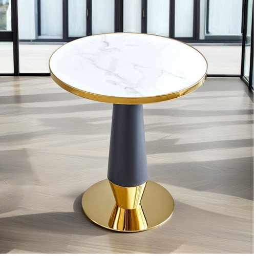Modern round marble top side table with gold accents in a bright room
