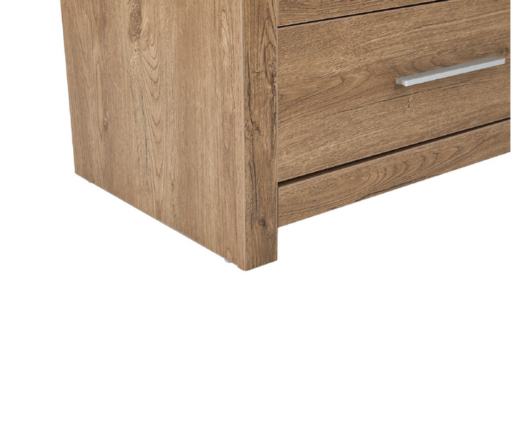 Close-up of wood grain drawer dresser corner with metal handle, home furniture