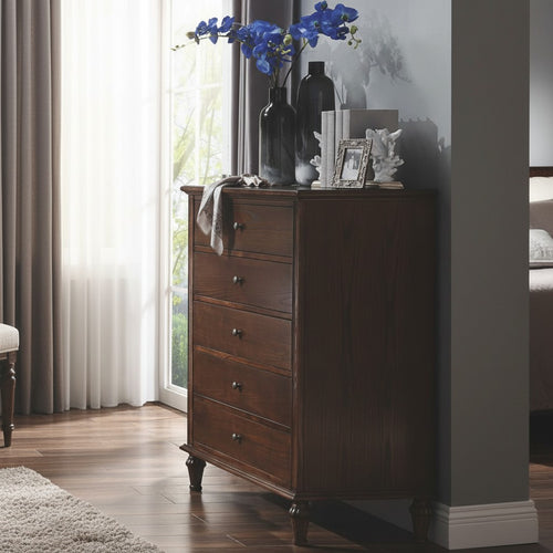 Dark wood chest of drawers in bedroom, decorated with blue flowers and vases