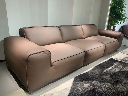 Modern brown leather sofa with plush cushions in Sydney furniture showroom