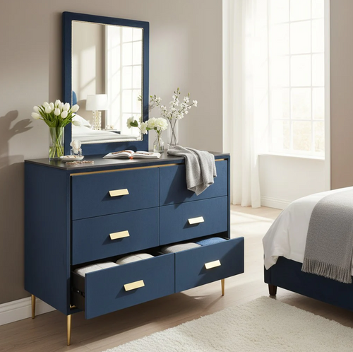 Navy blue dresser with gold handles and mirror, styled in modern bedroom with bed and flowers