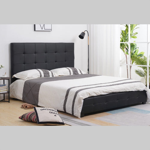 Modern black upholstered bed with tufted headboard in a bright bedroom