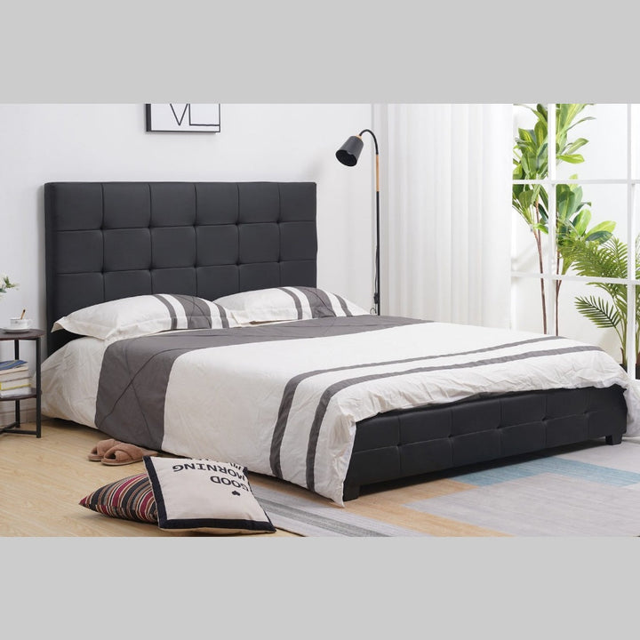 Modern black upholstered bed with tufted headboard in a bright bedroom