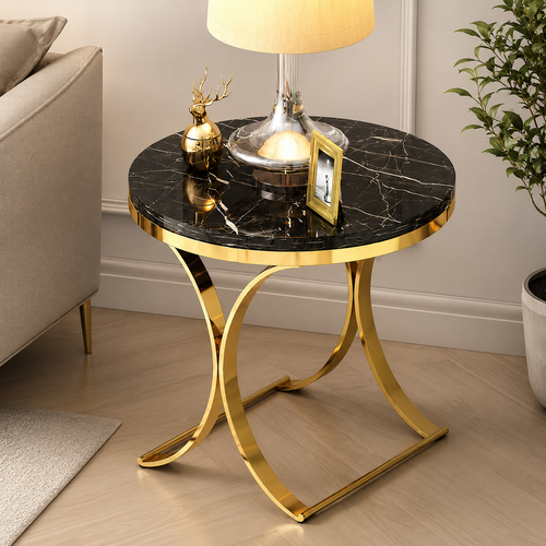 Luxury black marble side table with gold metal legs, styled with lamp and decor in modern living room