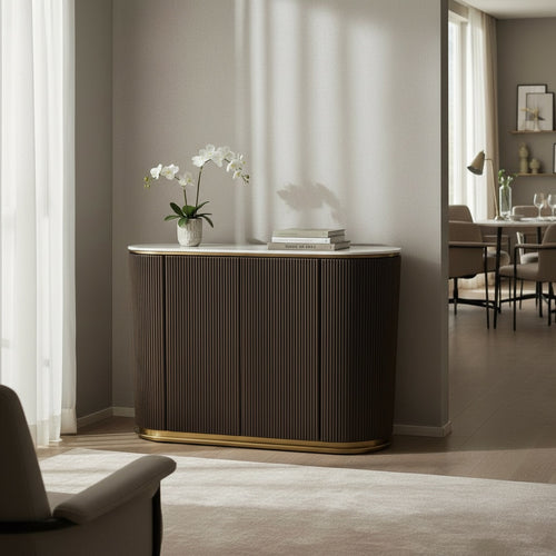 Modern wood sideboard with gold trim in a bright living room, orchid plant and books on top.