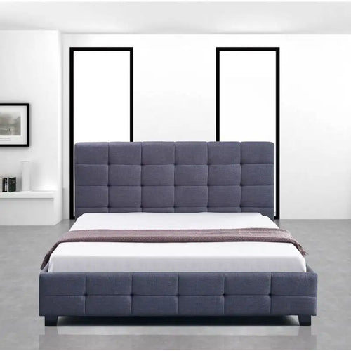Modern grey upholstered bed with square tufted headboard in minimal bedroom