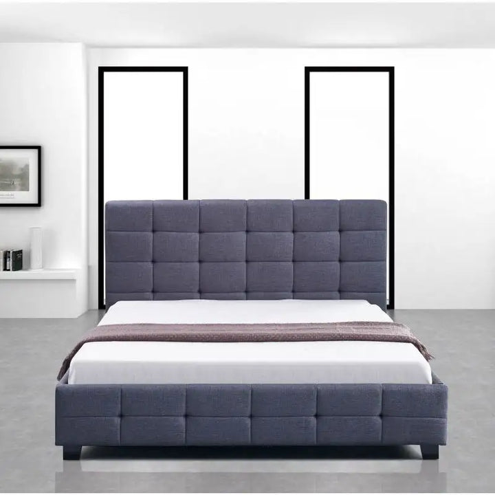 Modern grey upholstered bed with square tufted headboard in minimal bedroom